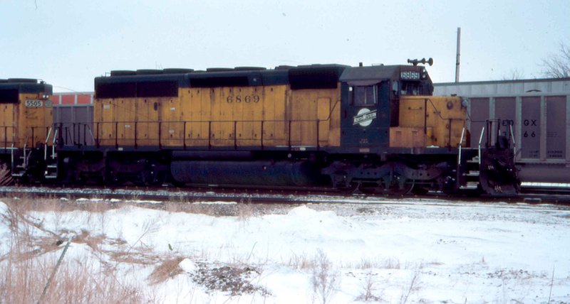 CNW 6869 leads a freight
